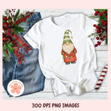 White sweatshirt with a Christmas gnome design on a wooden surface with festive decorations.