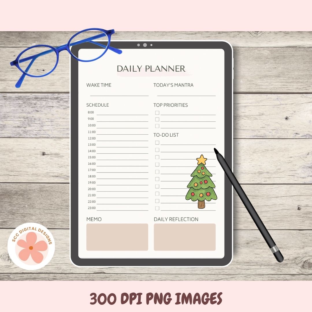 Daily planner on a tablet with a Christmas tree illustration, surrounded by glasses and a pen on a wooden surface.