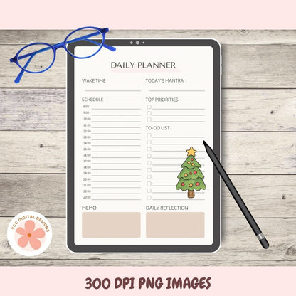 Daily planner on a tablet with a Christmas tree illustration, surrounded by glasses and a pen on a wooden surface.