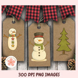Three Christmas-themed paper tags with a snowman, tree, and plaid banner on a wooden background.