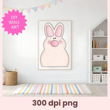 Framed cartoon bunny wall art in a room with a colorful rug and bookshelf.