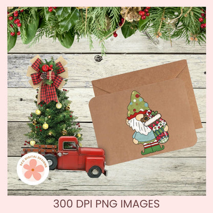 A holiday-themed digital design preview showing a kraft paper envelope with a gnome and Christmas tree illustration, alongside a small red truck and decorated tree on a rustic wood background. Text at the bottom reads '300 DPI PNG IMAGES' and a circular logo says 'EcoDigital Designs'.