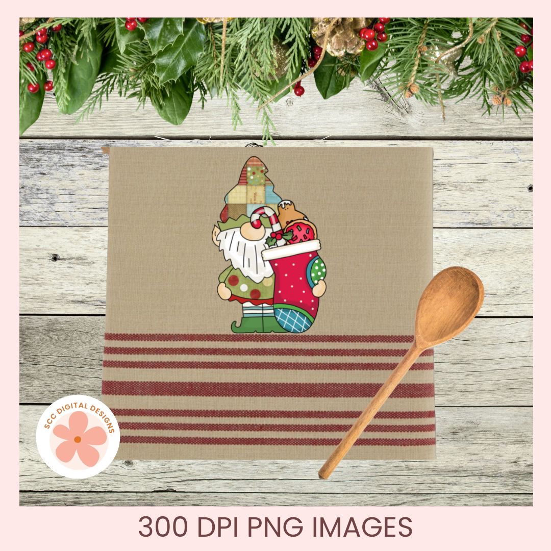 A Christmas-themed kitchen towel or placemat design shown on a rustic wood background with a wooden spoon and holiday greenery. The product has a tan center with a gnome hugging a stocking illustration and red horizontal stripes near the bottom.