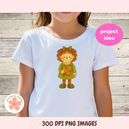 White t-shirt with a cartoon character holding a leaf, on a wooden background.