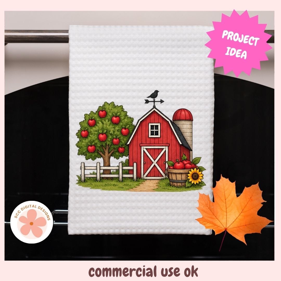 A white waffle-weave kitchen towel featuring a colorful autumn farm illustration with a red barn, apple tree, silo, and sunflower. The towel hangs on a dark oven door, with decorative pink 'PROJECT IDEA' and 'commercial use ok' text overlays.