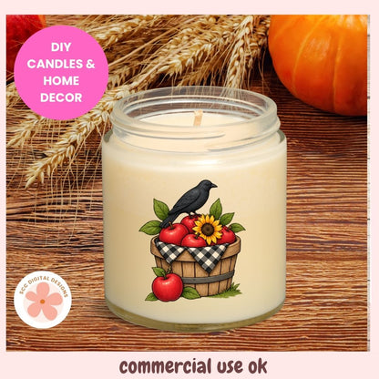A jar candle with cream-colored wax sits on a rustic wooden surface, decorated with a label showing a black bird perched on a basket of red apples with a sunflower. The background features decorative wheat stalks and a pumpkin, with text overlays reading 'DIY CANDLES & HOME DECOR' and 'commercial use ok'.