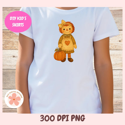A child wearing a white short-sleeve t-shirt with a cartoon autumn doll graphic holding a pumpkin on the front. The image has a pink border, a wood plank background, a pink 'DIY KID'S SHIRTS' badge, a circular '3CC Digital Designs' logo, and '300 DPI PNG' text at the bottom.