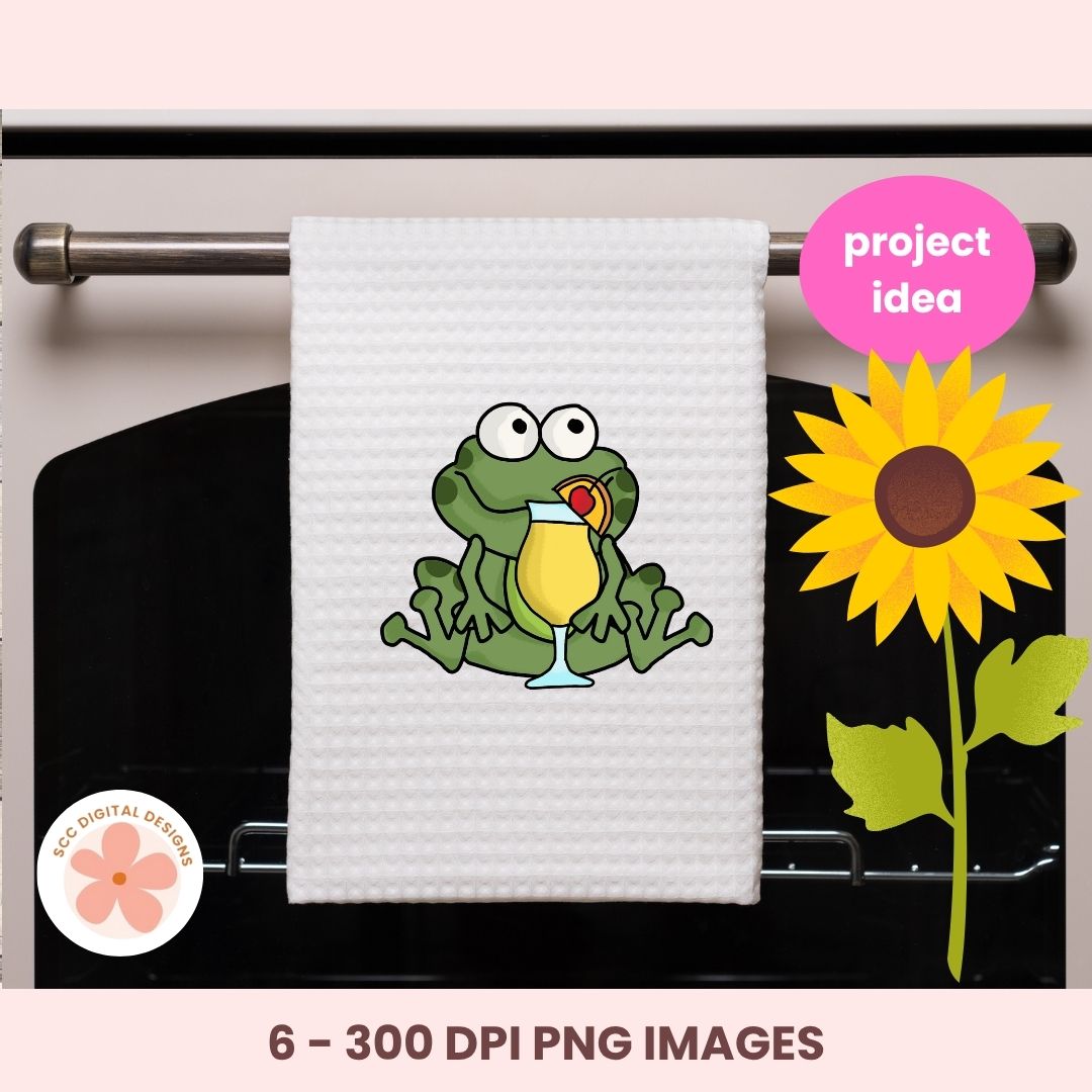 White towel with a cartoon frog holding a drink, hanging on a rack with a sunflower graphic and 'project idea' text.
