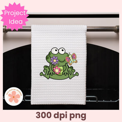 White towel with a green frog design hanging on a rack, featuring 'Project Idea' text.