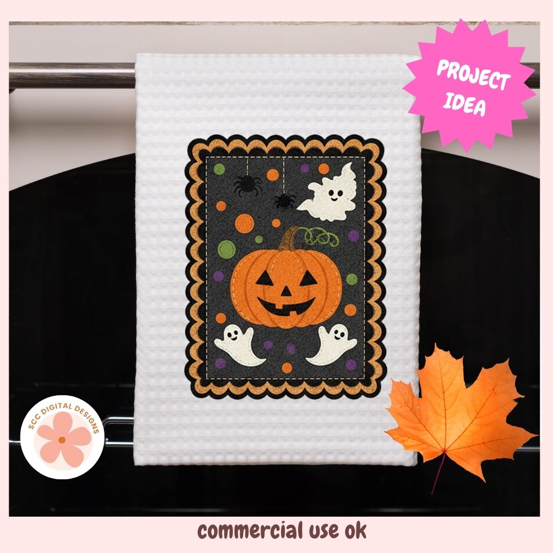 A white waffle-weave kitchen towel hanging on a dark oven door, featuring a colorful embroidered Halloween design with a jack-o'-lantern, ghosts, and orange dots. The image includes a pink 'PROJECT IDEA' starburst, a circular 'ECO DIGITAL DESIGN' logo, and a decorative orange maple leaf.