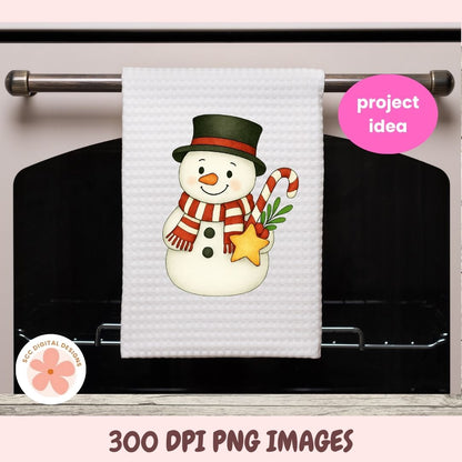 A white waffle-knit kitchen towel hanging on a metal oven rack, featuring a festive snowman design with a black top hat, red-and-white striped scarf, orange carrot nose, green pine sprig, and yellow star. The image includes a pink 'project idea' badge and a circular 'KCC DIGITAL DESIGNS' logo, with '300 DPI PNG IMAGES' text at the bottom.