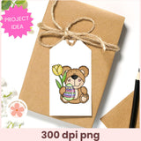 Gift box with a bear holding a tulip and Easter egg on a tag, with 'Project Idea' text and '300 dpi png' label.