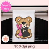 Towel with a teddy bear holding a Bible and bunny ears hanging on a towel rack.