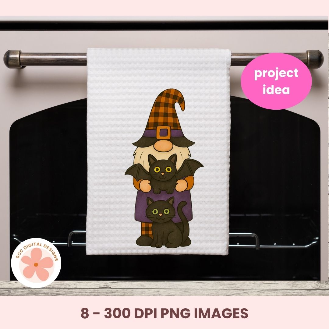 White towel with Halloween-themed design of a gnome, cats, and a bat on an oven.
