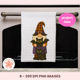 White towel with Halloween-themed design of a gnome, cats, and a bat on an oven.