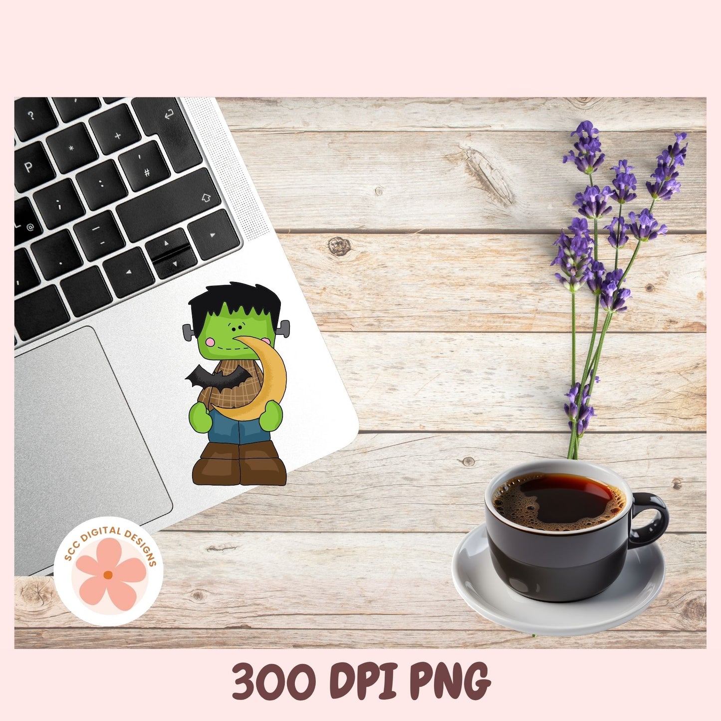 A digital mockup showing a cartoon Frankenstein sticker applied to a laptop trackpad, alongside a cup of coffee, lavender flowers, and a '300 DPI PNG' text banner on a light wood background.