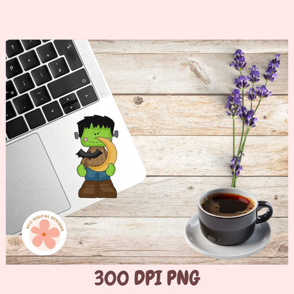 A digital mockup showing a cartoon Frankenstein sticker applied to a laptop trackpad, alongside a cup of coffee, lavender flowers, and a '300 DPI PNG' text banner on a light wood background.