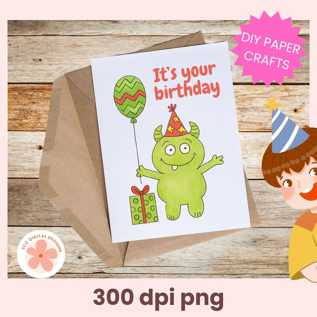 Birthday card with green monster illustration, envelope, and child character on wooden background