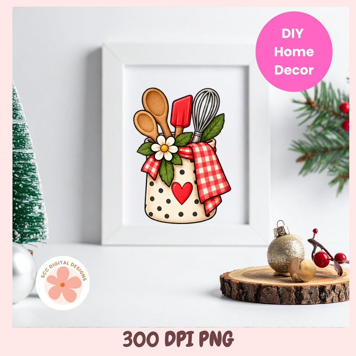 A framed kitchen utensil illustration displayed on a white surface with holiday props. The artwork shows a beige polka-dot jar filled with wooden spoons, a red spatula, a metal whisk, green leaves, a white flower, and a red gingham cloth with a red heart.