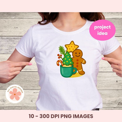 A white short-sleeve t-shirt with a colorful Christmas gingerbread man graphic, shown on a model against a rustic wood background. The graphic features a gingerbread man, a green mug, and a decorated Christmas tree.