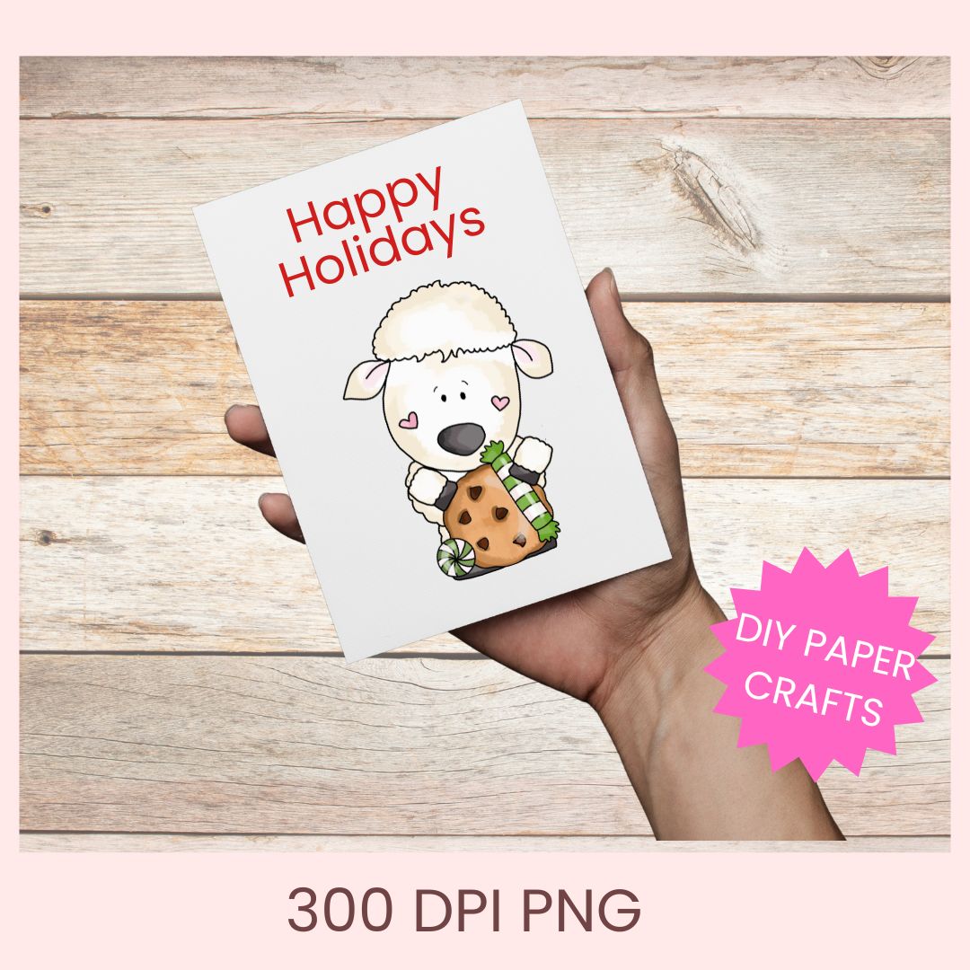 A hand holds a white greeting card with the text 'Happy Holidays' and a cartoon sheep holding a cookie, shown against a rustic wood background. A pink starburst says 'DIY PAPER CRAFTS' and text at the bottom reads '300 DPI PNG'.