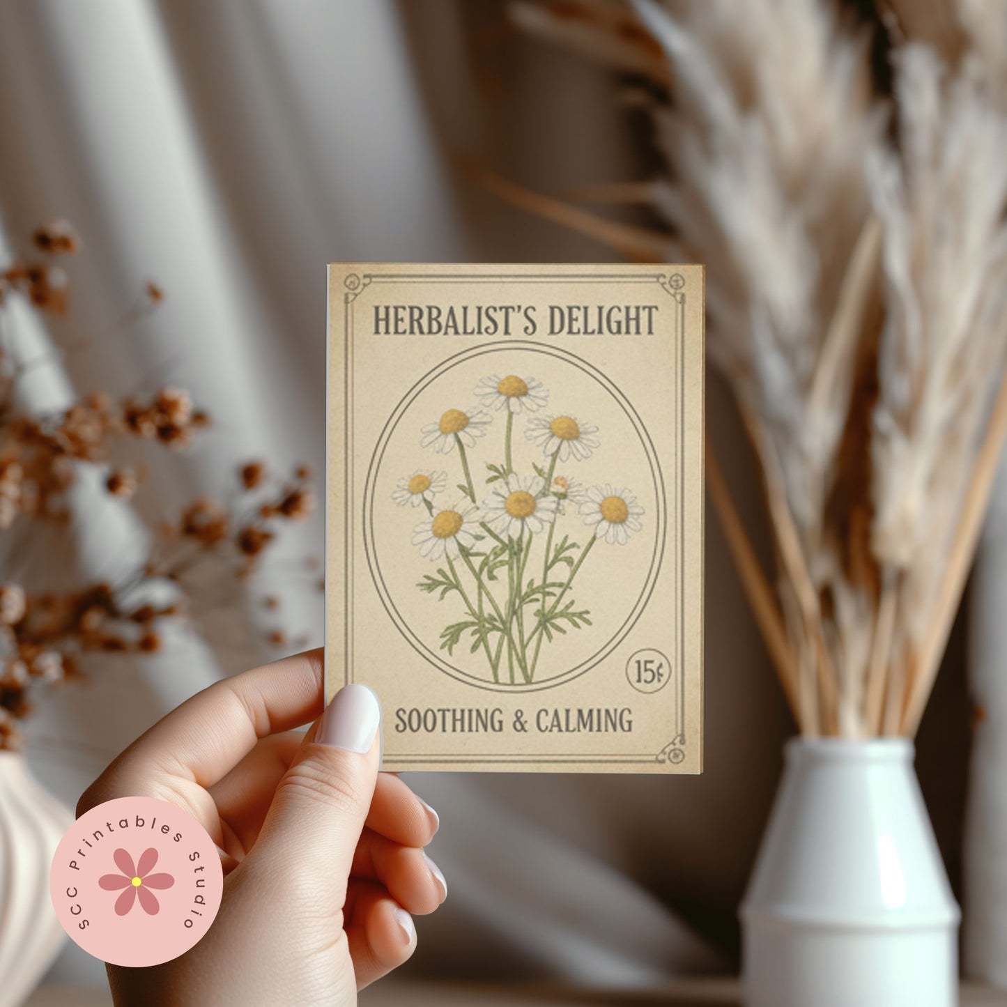 Hand holding a card with herbal design and text, with dried plants in the background