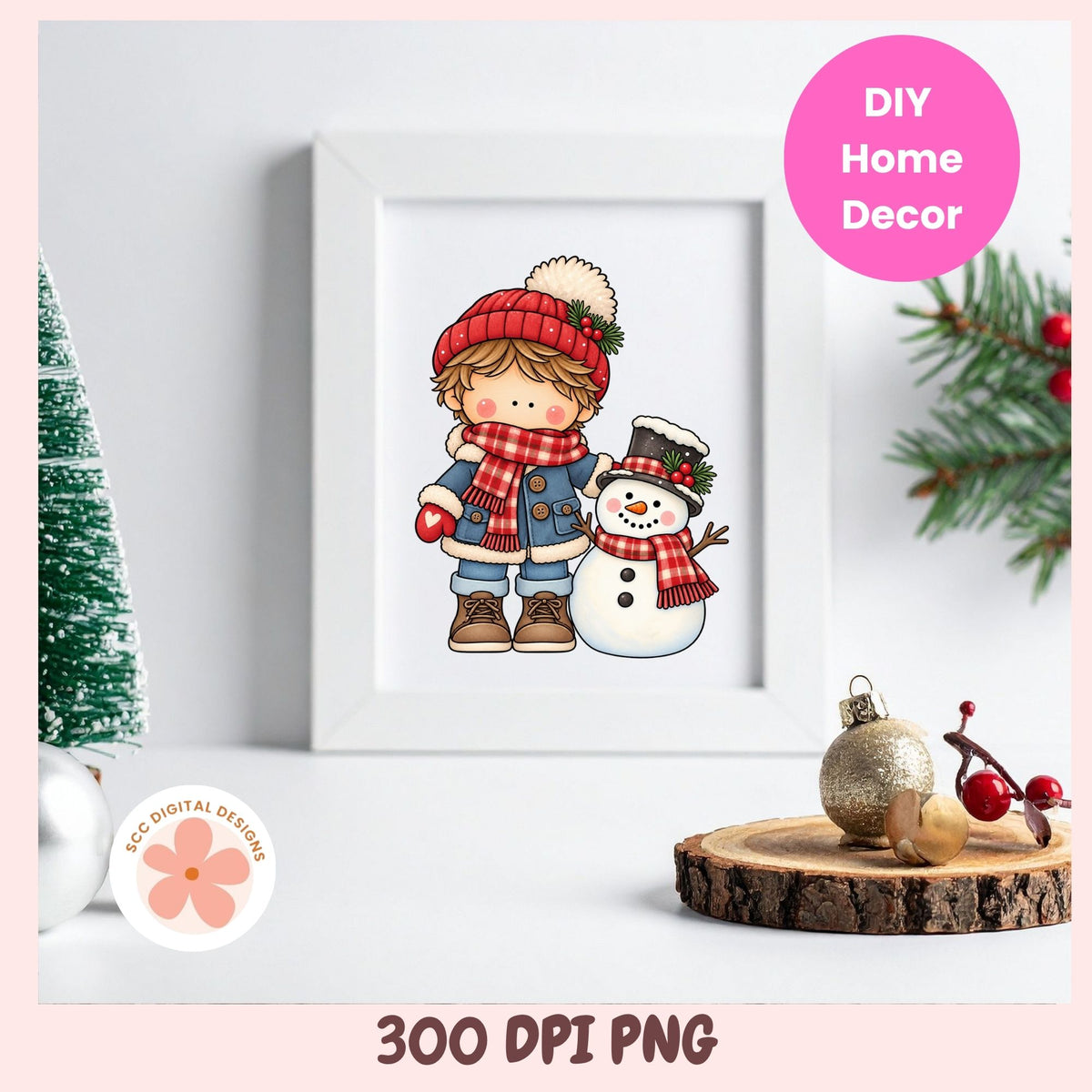 A framed holiday illustration showing a child in a red hat and scarf standing next to a snowman, displayed on a tabletop with Christmas decorations. The image includes text reading '300 DPI PNG' and a pink circle that says 'DIY Home Decor,' plus a small 'MCC Digital Designs' logo.