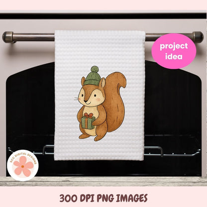 A white waffle-knit kitchen towel hanging from a metal oven rack, featuring a cartoon squirrel wearing a green beanie and holding a gift box. The image includes a pink 'project idea' badge and a circular '3D DIGITAL DESIGNS' logo, with text at the bottom reading '300 DPI PNG IMAGES'.