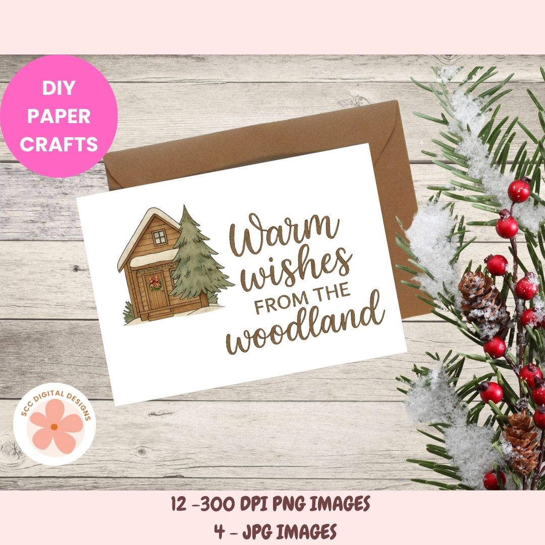 A digital card design mockup showing a white greeting card with a brown envelope, printed with a small cabin illustration and the phrase 'Warm wishes from the woodland' in brown script. The card is styled on a light wood surface with holiday greenery and red berries, plus pink promotional text banners reading 'DIY PAPER CRAFTS' and '12 -300 DPI PNG IMAGES 4 - JPG IMAGES'.