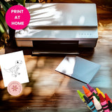 Printer on a wooden surface with a dinosaur drawing, blank paper, and crayons.