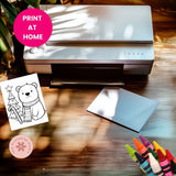 Printer on a wooden surface with a printed sheet of a bear and tree, and colorful markers.