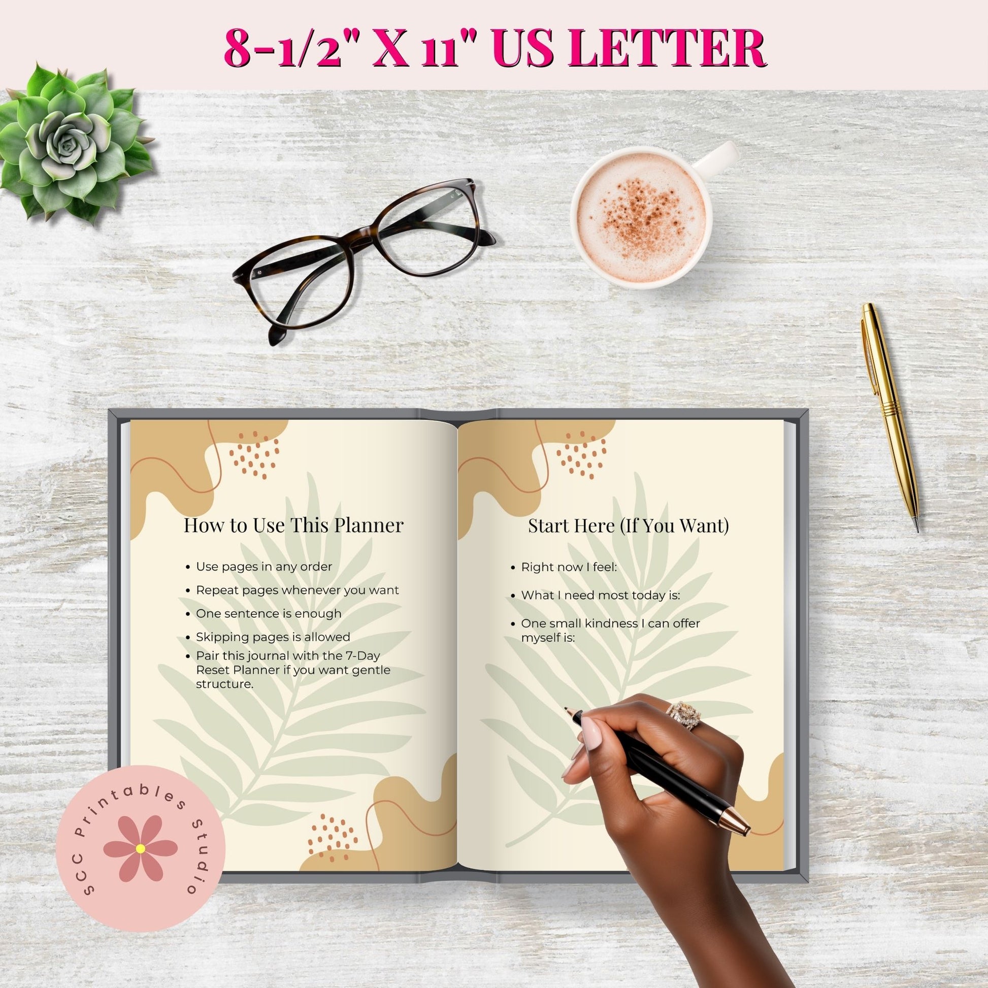 Open planner with instructions on a wooden surface with a cup of coffee, glasses, and pen.
