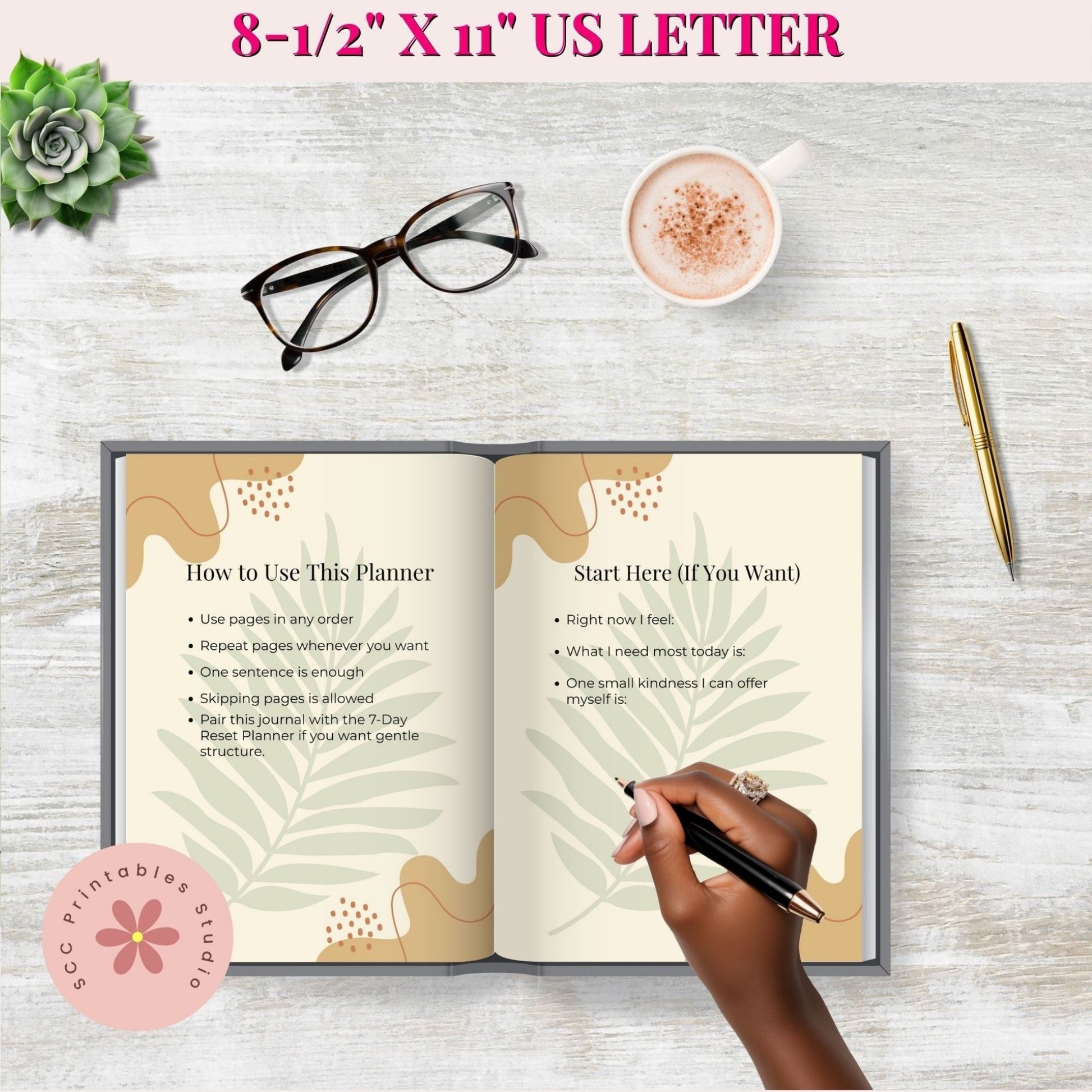 Open planner with instructions on a wooden surface with a cup of coffee, glasses, and pen.