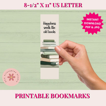Hand holding a printed bookmark with text on a light green background, featuring branding and product details.