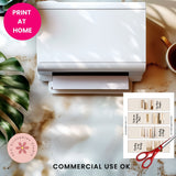 White printer on a desk with a cup, plant, and printed pages with text.