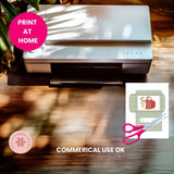 Printer on a wooden surface with a 'Print at Home' label and a small graphic of scissors and printed design.