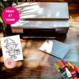 Printer on a wooden surface with a coloring book page and crayons, featuring 'Print at Home' text.