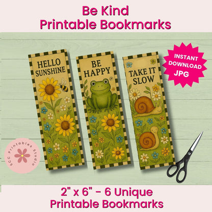 Three printable bookmarks with floral and animal illustrations are shown on a light wood background. The bookmarks read 'HELLO SUNSHINE,' 'BE HAPPY,' and 'TAKE IT SLOW,' with yellow sunflowers, a green frog, and brown snails.