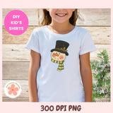 Child wearing a white t-shirt with a snowman design on a wooden background