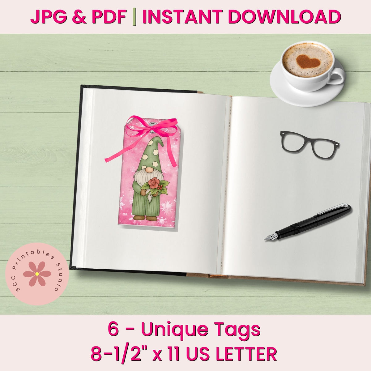 A digital mockup showing a printable bookmark tag with a gnome design and pink ribbon, placed on an open notebook. The image includes text reading 'JPG & PDF | INSTANT DOWNLOAD', '6 - Unique Tags', and '8-1/2" x 11 US LETTER', plus a coffee cup, eyeglasses, and pen as styled props.