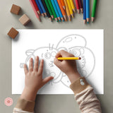 Child coloring a mandala with colored pencils on a gray surface