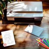 Printer on a wooden surface with a coloring book page and colored pencils.