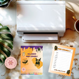Halloween-themed word scramble game with a printer on a desk
