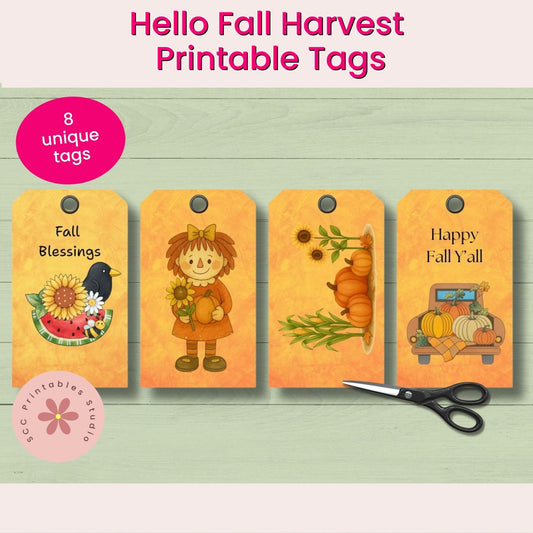 Four fall-themed printable tags with illustrations and text on a wooden surface with scissors.