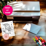 Printer on a table with a coloring book page, paper, and markers.