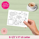 Hand holding a Mother's Day coloring sheet with a cup of coffee on a green surface.