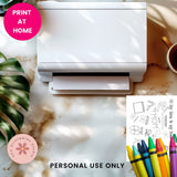 White printer on a marble surface with crayons and a coloring book, featuring 'Print at Home' and 'Personal Use Only' text.