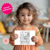 Child holding a coloring page with a green pencil, in a casual indoor setting.