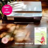 Printer on a wooden surface with a 'Print at Home' label and a Christmas-themed card.