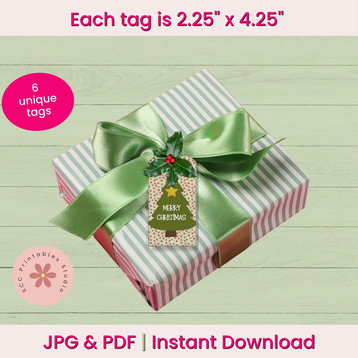 Digital mockup of a wrapped gift box with a green satin ribbon and a Christmas-themed printable tag, on a light wood background with promotional text overlays.